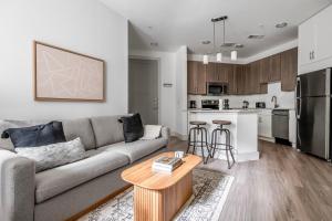 a living room with a couch and a kitchen at Downtown 1br w deck gym nr Congress Ave ATX-208 in Austin