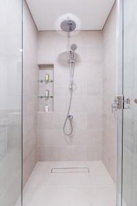 a bathroom with a shower with a glass door at Nasma Luxury Stays - Fabulous Apartment With Balcony Near MJL's Souk in Dubai