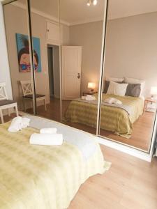 a bedroom with two beds and a large mirror at JAM Retreat in Lisbon