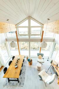 a room with a table and chairs in a house at Vaeranes- Ny hytte med flott utsikt in Ramberg