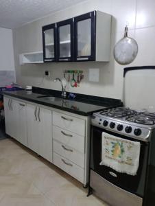 a kitchen with a stove and a sink at Agradable Apto San Luis in Bucaramanga