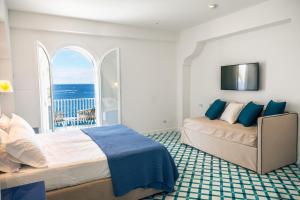 a bedroom with two beds and a view of the ocean at Villa Biancalisa in Massa Lubrense +50 photos