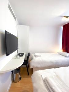 Postel nebo postele na pokoji v ubytování Citizen Suites