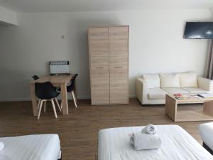 a living room with a couch and a table at Room in Studio - Value Stay Residence Mechelen - Studio Triple in Mechelen