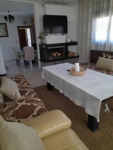 a living room with a table and a fireplace at superbe appartement bien placé in Fès