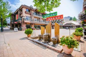 a street sign in front of a building with potted plants at Pinewood Getaway in Ketchum
