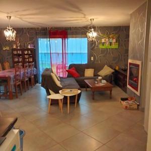 a living room with a couch and a table at Chambre chez l habitant 2 in Moumour