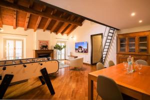 a living room with a pool table and a dining room at Luxury apartment + private parking - Como center in Como
