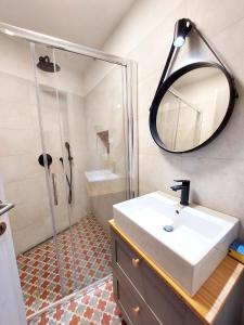 a bathroom with a sink and a shower with a mirror at Selo Station in Črniče