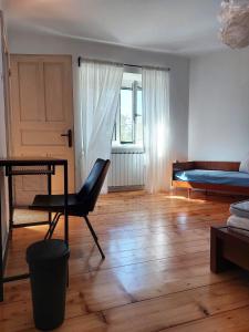 a room with a desk and a bed and a chair at Selo Station in Črniče +22 photos
