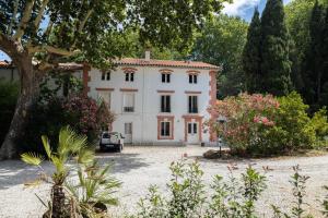a house with a car parked in front of it at Domaine Castell de Blés in Saint-Genis-des-Fontaines