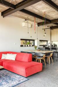 a living room with a red couch and a table at Między Drzewami in Olsztyn