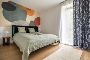 a bedroom with a bed and a large window at K13 House in Szentendre