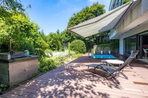 a patio with a grill and a table and chairs at K13 House in Szentendre