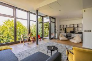 an open living room with large windows at K13 House in Szentendre