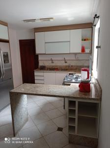 a kitchen with a counter with a appliance on it at Casa de praia in Salvador