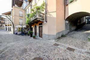 an empty street in a city with buildings at Il Vicolo Suite Apartments-Il Cortiletto in Tignale