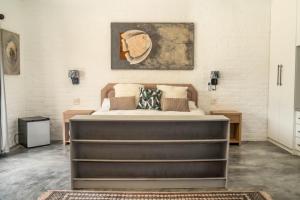 a bedroom with a large bed in a room at SkatKus Eco Estate in Stilbaai-Wes