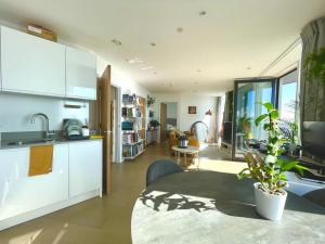 a kitchen with a sink and a table in a room at Luxury One-Bedroom Apartment with a View - Barking in London