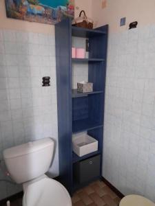 uma casa de banho com um WC e uma prateleira azul em Villa Récompense Côte Atlantique n3 em Soulac-sur-Mer