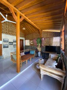 a living room with a couch and a table at Hideaway Batukaras in Pangandaran