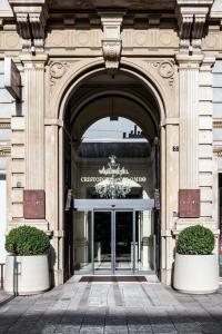 an entrance to a building with a chandelier at Worldhotel Cristoforo Colombo in Milan