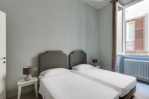 Posteľ alebo postele v izbe v ubytovaní Apartments Florence-Ginori Terrace