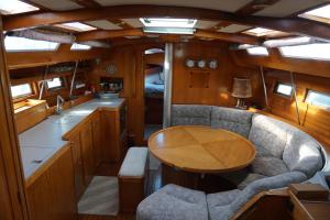 a dining area in a boat with a table at Gloria Sailing in Porticello