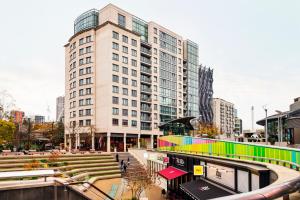 a large building with a colorful facade in a city at Paddington Basin View Apartment in London
