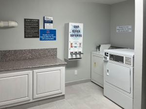 a kitchen with white appliances and a counter top at Motel 6 Nacogdoches TX SFA University in Nacogdoches