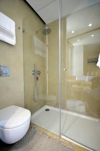a bathroom with a shower and a toilet and a sink at Villa 292 in Caminha