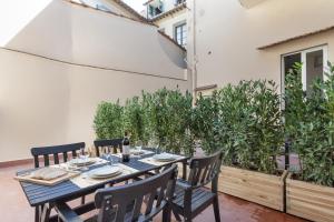 フィレンツェにあるApartments Florence-Taddea Terraceの植物のあるパティオ(テーブル、椅子付)