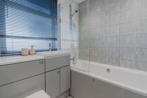 a bathroom with a tub and a sink and a shower at The Perfect Welsh Oasis in Newport