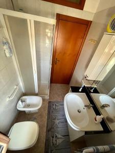 a bathroom with a sink and a toilet and a mirror at La Panchina sul Corso in Grassano +22 photos