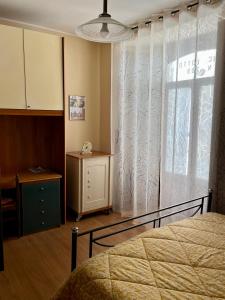 a bedroom with a bed and a window and a dresser at La Panchina sul Corso in Grassano
