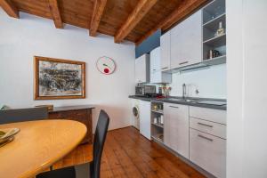 eine Küche mit einem Tisch und einem Esszimmer in der Unterkunft Atelier San Giacomo - Central Apartment in Udine