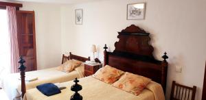 a bedroom with two beds and a headboard at Casa Margarita in Sóller