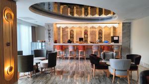 a bar in a restaurant with chairs and a counter at Side Zeugma Hotel - Adult Only 16 Plus in Side