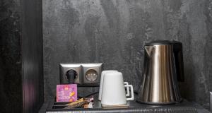 a coffeemaker sitting on a shelf with a coffee maker at PLAZA INN Mühldorf in Mühldorf