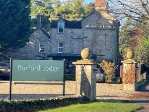 a sign for the burford lodge in front of a building at Burford Lodge - Adults only in Burford
