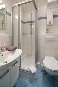 ein Bad mit einer Dusche, einem Waschbecken und einem WC in der Unterkunft Haus Bielefeld Ferienwohnung 12 in Norderney
