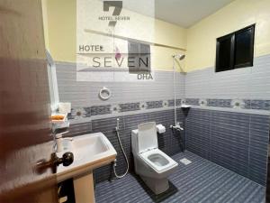 a bathroom with a toilet and a sink at Hotel 7 DHA in Karachi +56 photos