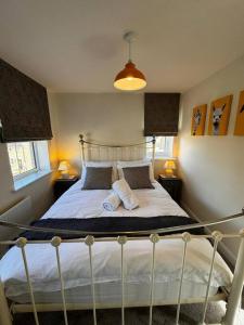 a bedroom with a bed with two pillows on it at Peak View - Modern Cottage in Buxton