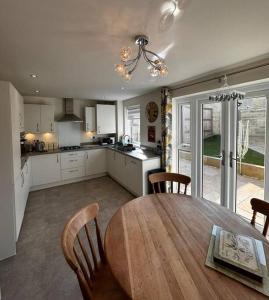 a kitchen and dining room with a table and chairs at Peak View - Modern Cottage in Buxton