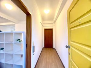 an open door leading to a hallway with a wooden floor at Ericeira Panoramic Sea View Apartments in Ericeira