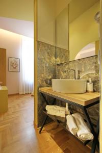 uma casa de banho com um lavatório num balcão com toalhas em Dreaming Rome Suites em Roma