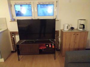 a large flat screen tv in a living room at Ferienwohnung in Espenau