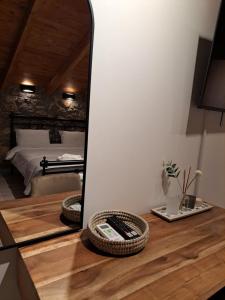 a mirror on top of a wooden table in a bedroom at Villas Kertezi in Kalavrita