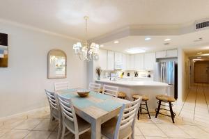 a kitchen and dining room with a table and chairs at Enclave 304 in Orange Beach