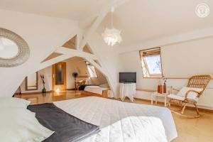a bedroom with a large bed and a living room at Entre ciel & Loire in Saint-Agnan-sur-Loire